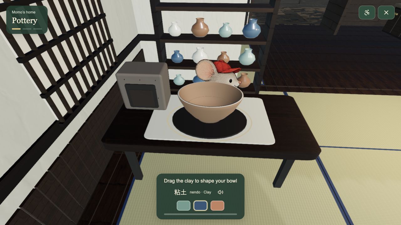 Momo at the pottery table with a clay bowl and shelves of glazed pots